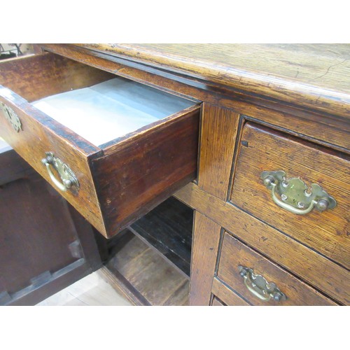 643 - An 18th Century oak and mahogany crossbanded enclosed Dresser Base fitted three frieze drawers above... 