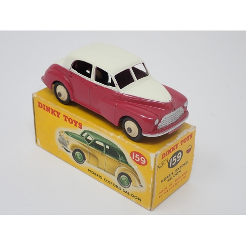 1155 - A boxed Dinky Toys No.159 maroon and cream Morris Oxford Saloon