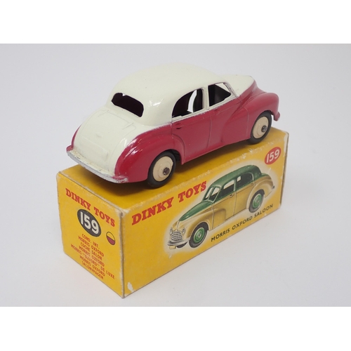 1155 - A boxed Dinky Toys No.159 maroon and cream Morris Oxford Saloon