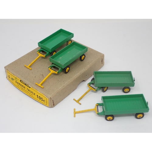 1210 - A Dinky Toys No.105C Trade Box containing four Garden Trucks