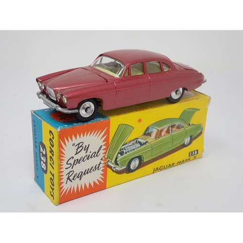 1215 - A boxed Corgi Toys No.238 metallic red Jaguar Mark 10 with luggage