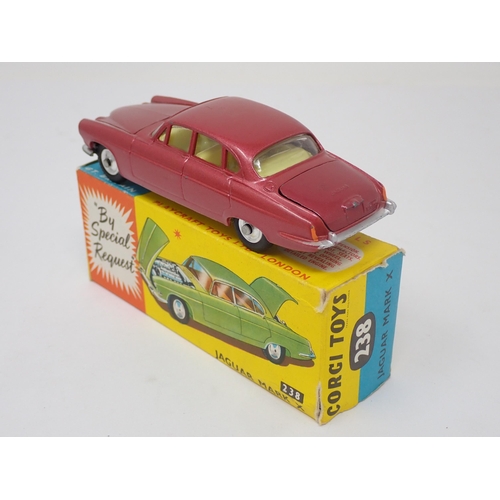 1215 - A boxed Corgi Toys No.238 metallic red Jaguar Mark 10 with luggage