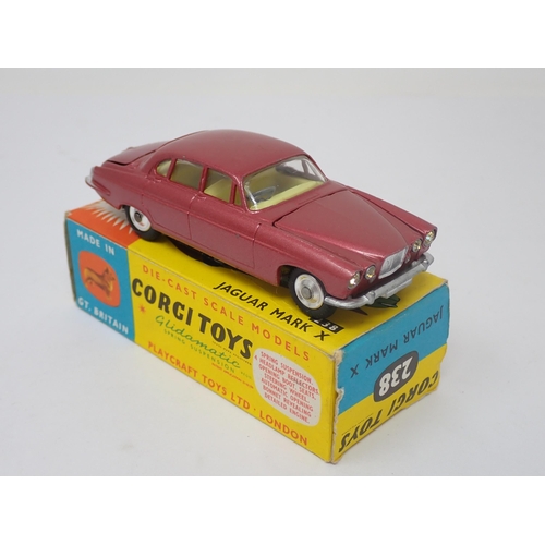 1215 - A boxed Corgi Toys No.238 metallic red Jaguar Mark 10 with luggage