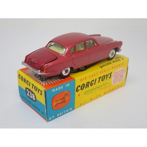 1215 - A boxed Corgi Toys No.238 metallic red Jaguar Mark 10 with luggage