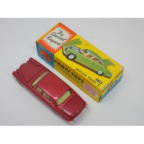 1215 - A boxed Corgi Toys No.238 metallic red Jaguar Mark 10 with luggage