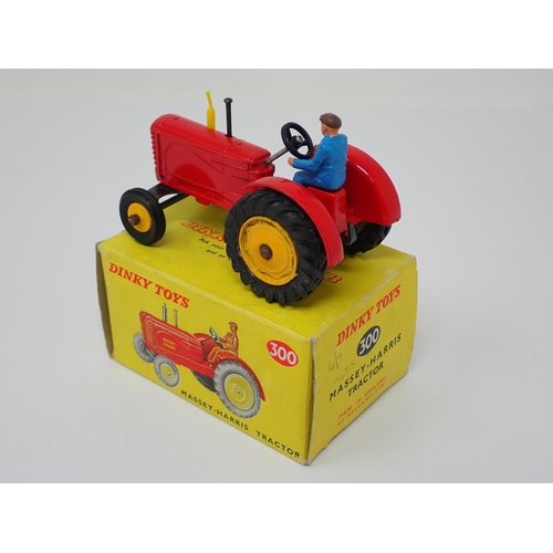 1231 - A boxed Dinky Toys No.300 Massey-Harris Tractor with yellow hubs