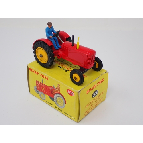 1231 - A boxed Dinky Toys No.300 Massey-Harris Tractor with yellow hubs