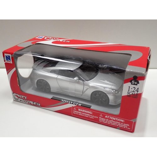 1291 - Two boxed Motor Max 1:24 scale Models and a Proswon 1:32 Model, City Cruise Nissan GT-R