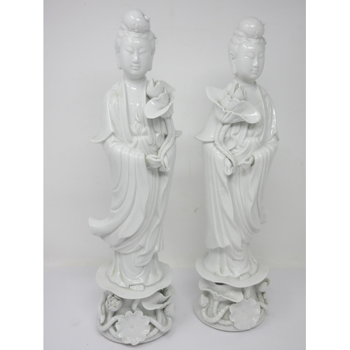 13 - A pair of Chinese blanc de chine Figures holding lilies, 16in