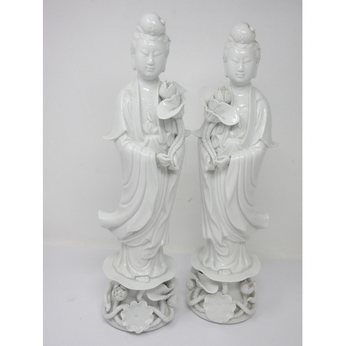 13 - A pair of Chinese blanc de chine Figures holding lilies, 16in