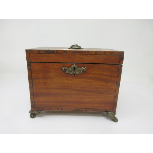 20 - A late Georgian mahogany Tea Caddy with cross-banding and stringing, embossed brass escutcheon, hand... 