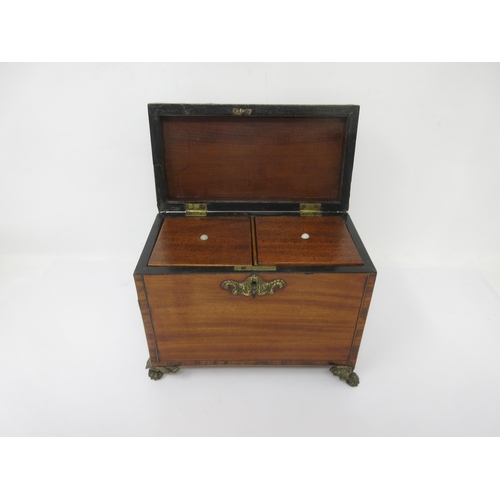 20 - A late Georgian mahogany Tea Caddy with cross-banding and stringing, embossed brass escutcheon, hand... 