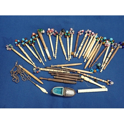 201 - A collection of bone and wooden Lace Bobbins, white metal Thimble in case etc