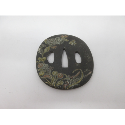 21 - A Japanese Tsuba with floral and insect design in three colours