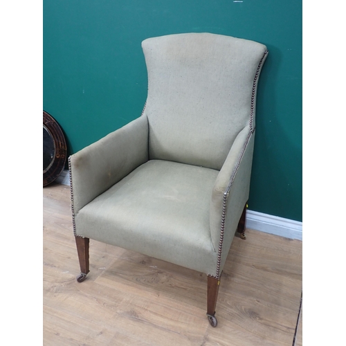 226 - A 19th Century green upholstered Armchair on square cut tapering supports