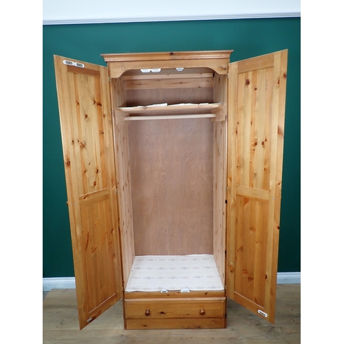 231 - A modern pine two door Wardrobe, Chest of drawers and Bedside Chest