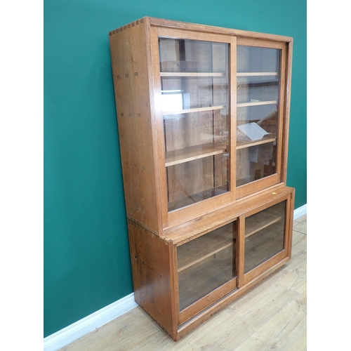 234 - An oak Bookcase with sliding glass doors enclosing fixed shelves 5ft 8in H x 4ft W