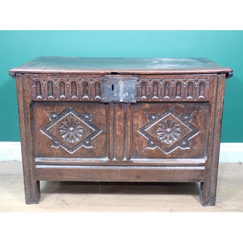 255 - A 17th Century oak Coffer with moulded lid above nulled frieze and rosette carved two panel front 2f... 