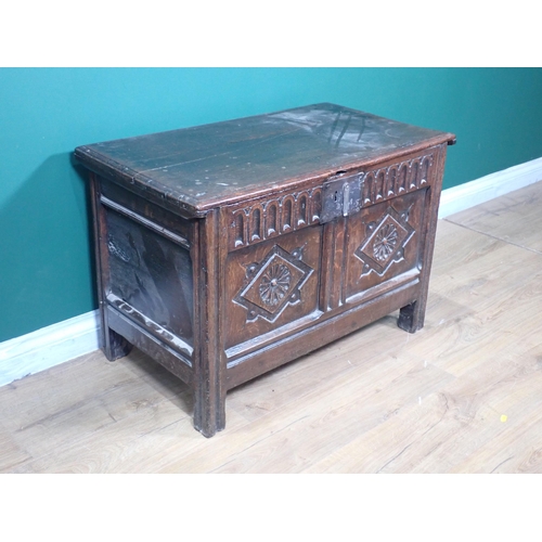 255 - A 17th Century oak Coffer with moulded lid above nulled frieze and rosette carved two panel front 2f... 