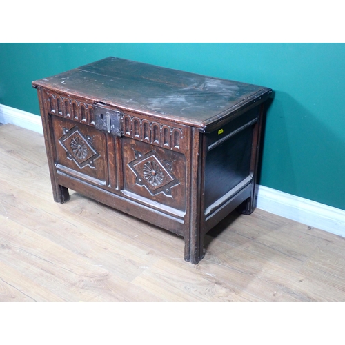 255 - A 17th Century oak Coffer with moulded lid above nulled frieze and rosette carved two panel front 2f... 