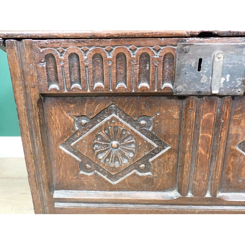 255 - A 17th Century oak Coffer with moulded lid above nulled frieze and rosette carved two panel front 2f... 