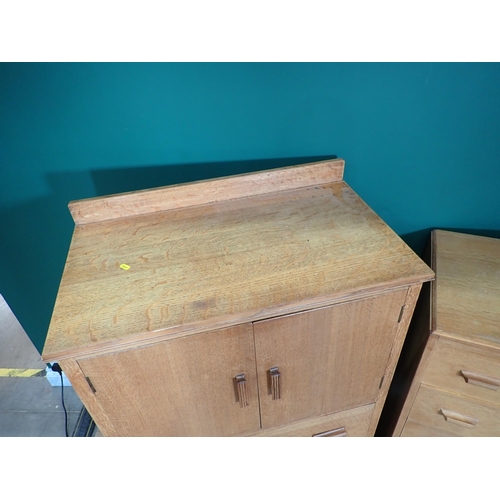 285 - An oak Cupboard fitted two drawers to base and a Chest of drawers