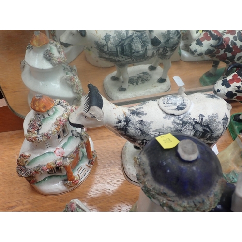 303 - A collection of Staffordshire Pastille Burners, Cow Creamer and Figures