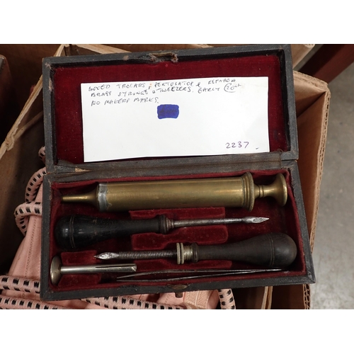 304 - A box of Scientific Instruments including brass syringe, Enema, Truss, etc.