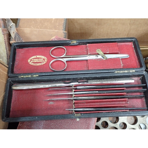 304 - A box of Scientific Instruments including brass syringe, Enema, Truss, etc.