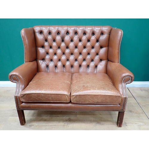 323 - A Georgian style brown leather button back wingback Sofa on square cut supports 4ft W x 3ft 2in H