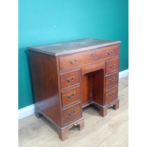 346 - A 19th Century mahogany Kneehole Desk fitted eight drawers and recessed cupboard door mounted on bra... 