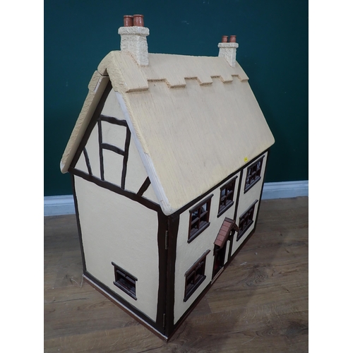 357 - A thatched roofed Dolls' House 2ft 8in H x 2ft 4in W