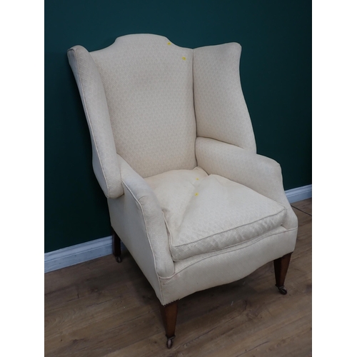 377 - An Edwardian wingback Armchair mounted on square cut tapering supports and casters 4ft H x 2ft 8in W