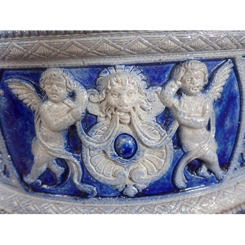 382 - A Westerwald Urn with moulded cherub frieze and two handles in the form of mythical beasts 1ft 7in H