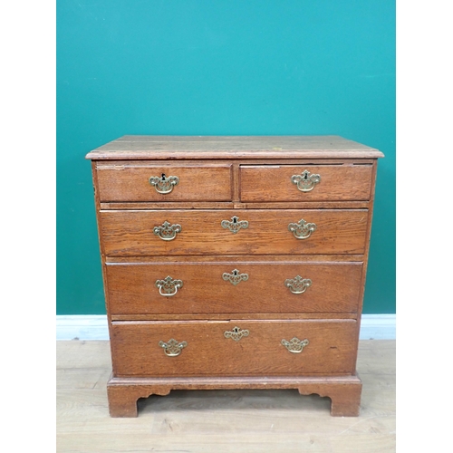 384 - A George III oak Chest of two short and three long graduated drawers mounted on ogee bracket feet 2f... 