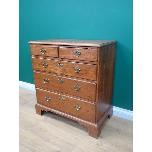 384 - A George III oak Chest of two short and three long graduated drawers mounted on ogee bracket feet 2f... 