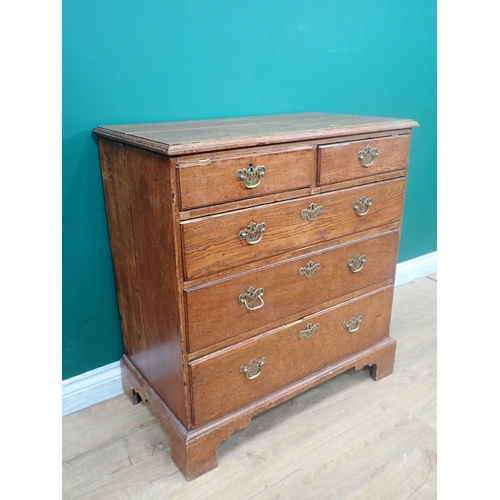 384 - A George III oak Chest of two short and three long graduated drawers mounted on ogee bracket feet 2f... 