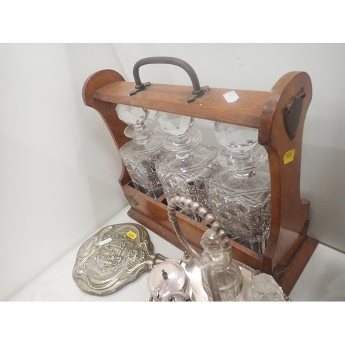 488 - An oak Tantalus with three Decanters, plated Cruet Set, Dressing Mirror, brass Clock Face and an old... 