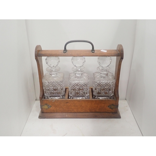 488 - An oak Tantalus with three Decanters, plated Cruet Set, Dressing Mirror, brass Clock Face and an old... 