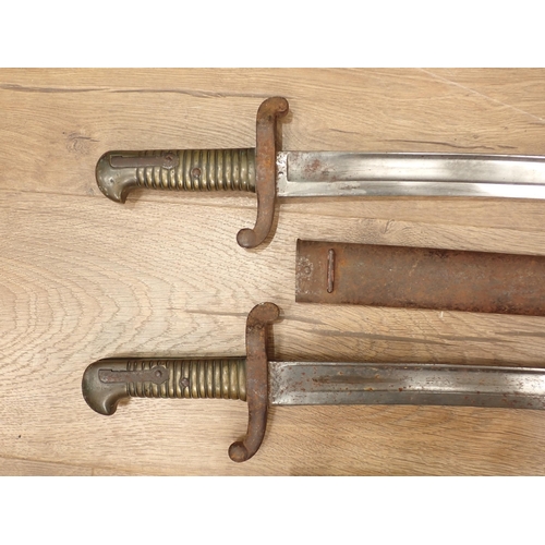 1457 - Two French brass handled Bayonets in metal scabbards