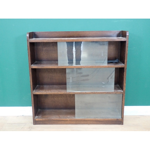 553 - An oak Bookcase with sliding glass doors