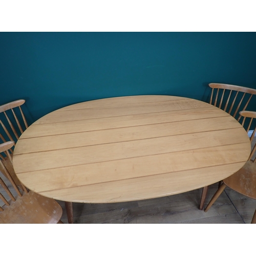 562 - A Gordon Russell oval Dining Table 5ft 4in L x 2ft 5in H and four Ercol style back Chairs