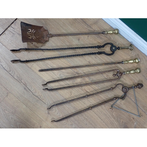 567 - A 19th Century steel and brass Fire Companion Set and two pairs of Tongs