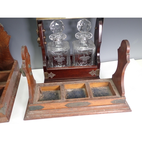 599 - A Tantalus with two decanters, an oak Tantalus without decanters and an incomplete Tantalus