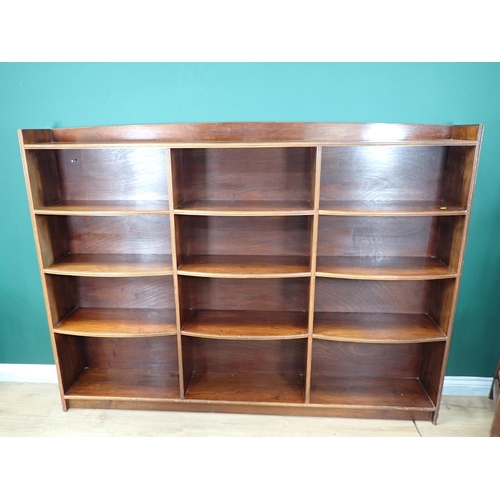 652 - A mahogany open Bookcase with bowfront shelves and carved detail, 4ft 6in H x 6ft 1in W