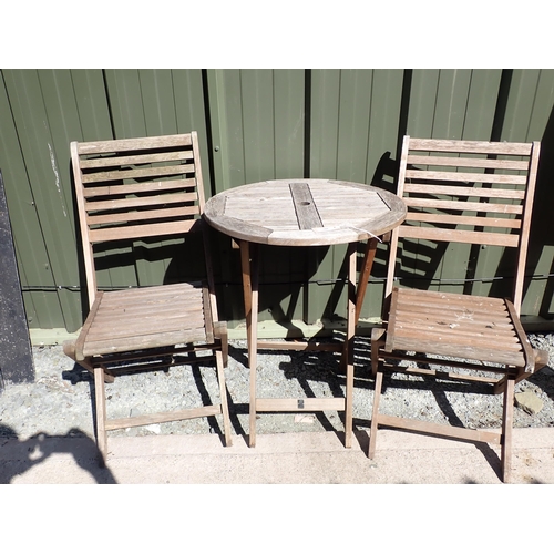 744 - A small teak folding Bistro Table and a pair of folding Chairs