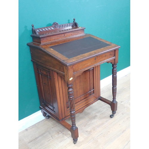 752 - A late Victorian Davenport Desk, fitted cupboard door to the side enclosing drawers and raised on ca... 