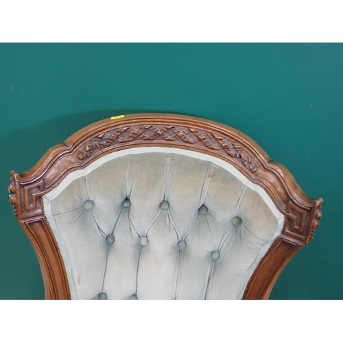 753 - A Victorian button back Armchair on carved cabriole supports and casters