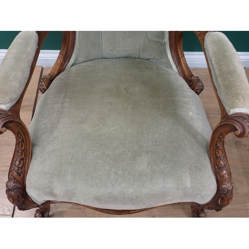 753 - A Victorian button back Armchair on carved cabriole supports and casters