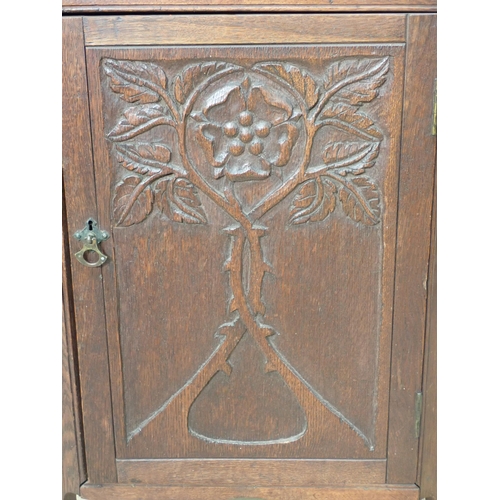 775 - A small oak Hanging Corner Cupboard with carved door, 3ft h